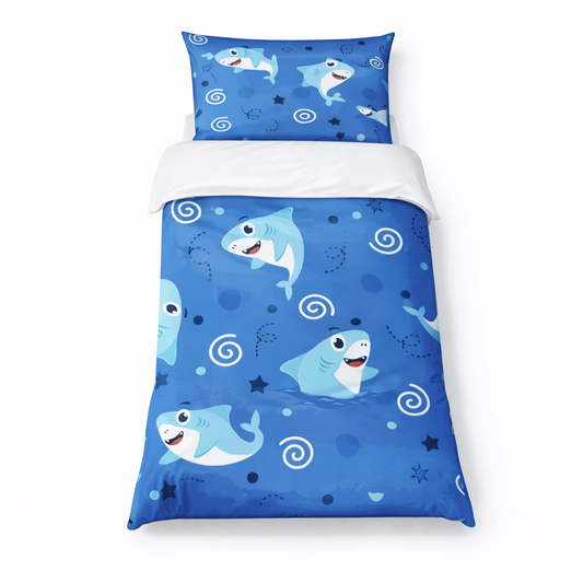 Children's bedroom with blue shark-themed bedding set on a bed on a white background