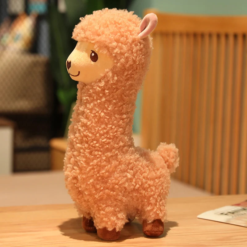 Brown plush toy llama on a wooden table with a blurred background