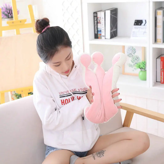 Person pushing the crown pillow from the sides to show softness and flexibility.