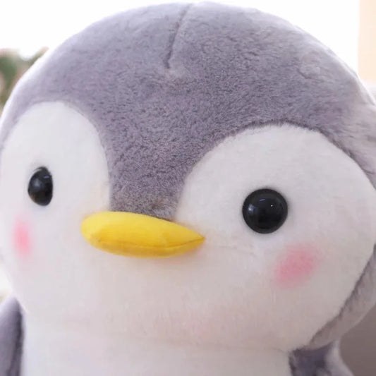 Close-up of a plush toy penguin with a soft focus background
