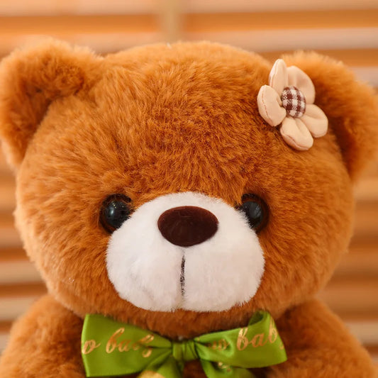 Close up of the a soft plush brown bear facial detailing.