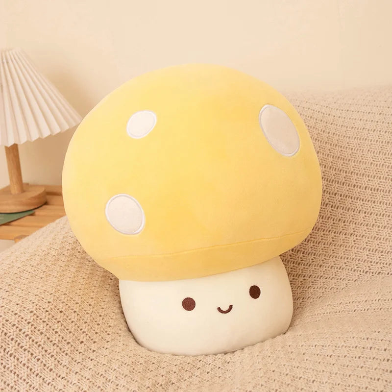 Yellow soft plush mushroom toy on a soft surface.