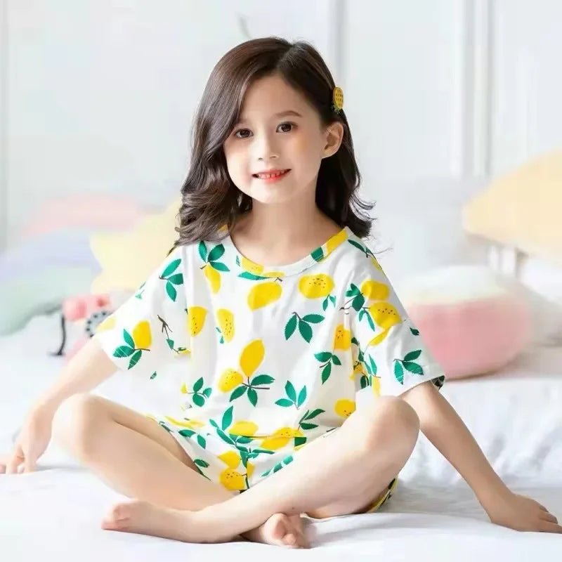 Girl in a cosy room wearing lemon print pyjamas