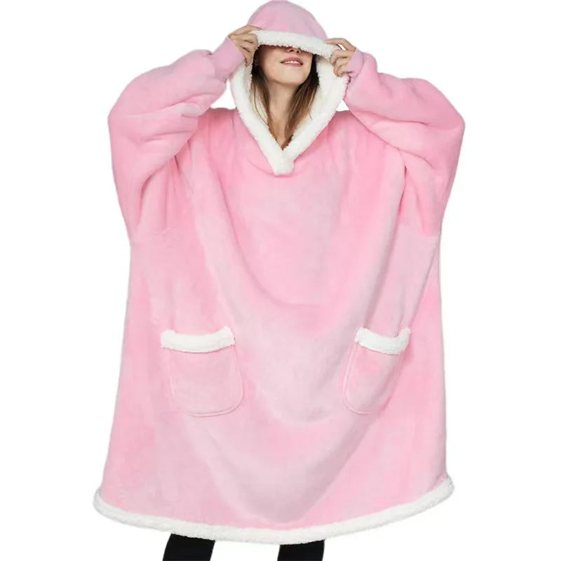 Woman wearing a pink thick oversized hoodie on a white background.