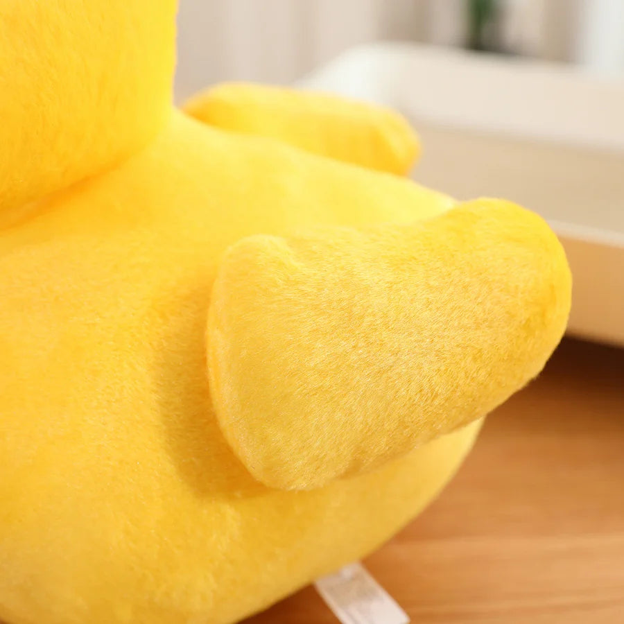Close-up of the wing detail on a yellow duck plush toy, showing the soft plush texture