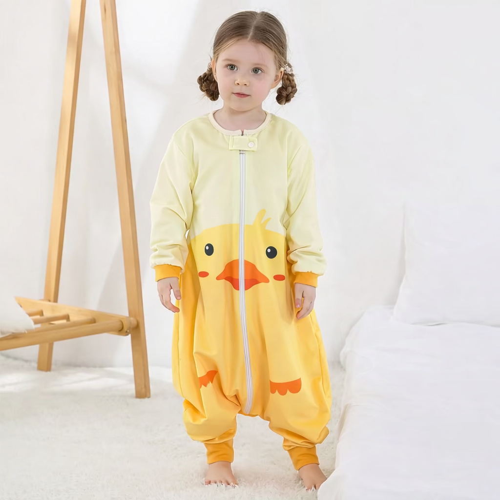 Child wearing a yellow duck-themed onesie in a cosy room