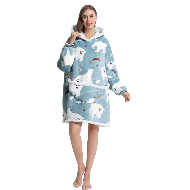 A woman wearing a blue polar bear design oversized hoodie on a white background.