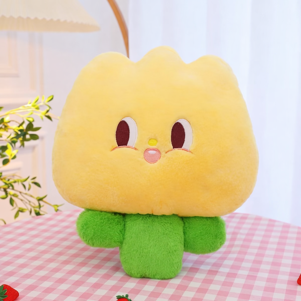 Yellow plush soft tulip toy on a table in a comfortable setting.