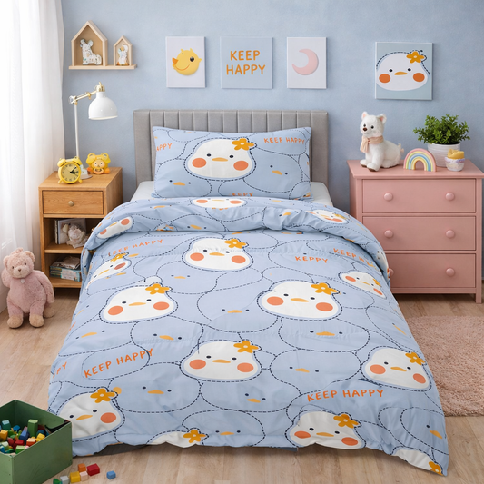 Blue duvet set with cute chick face pattern and small floral details displayed on a single bed with matching pillowcase