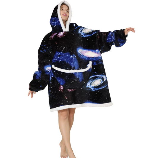 Adult wearing galaxy-themed oversized wearable hoodie with hood and front pocket.