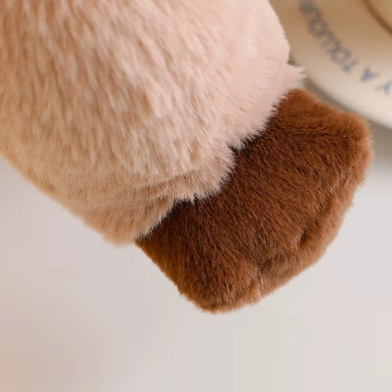 Close-up of brown paw detail on an otter soft toy, showing the soft plush texture