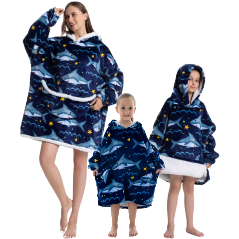 Adult and two children wearing blue shark design oversized wearable hoodies