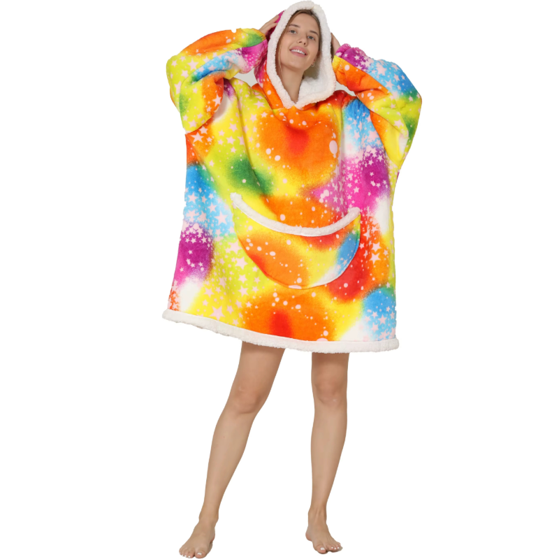 Adult wearing a colourful oversized wearable hoodie with psychedelic galaxy spiral pattern and soft sherpa lining