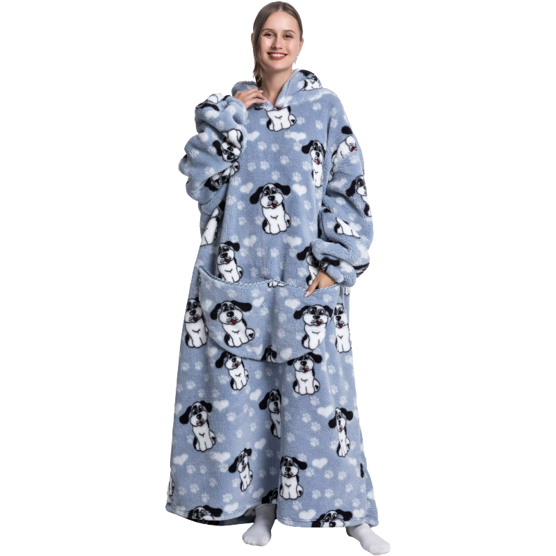 Person wearing a blue fleece blanket with dog patterns on a white background