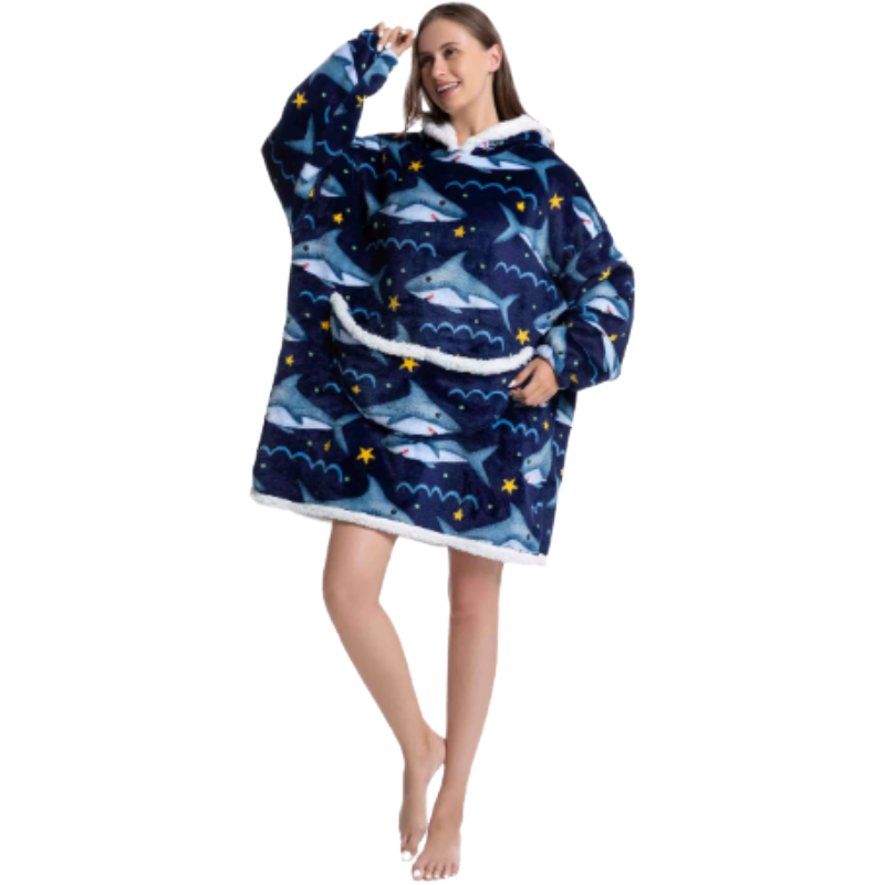 Woman wearing a blue shark themed oversized lounge hoodie on a white background.