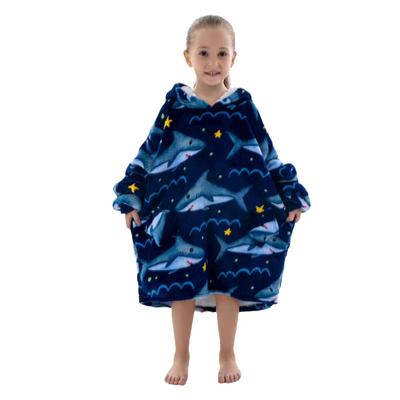 Child wearing a blue shark themed oversized lounge hoodie on a white background.