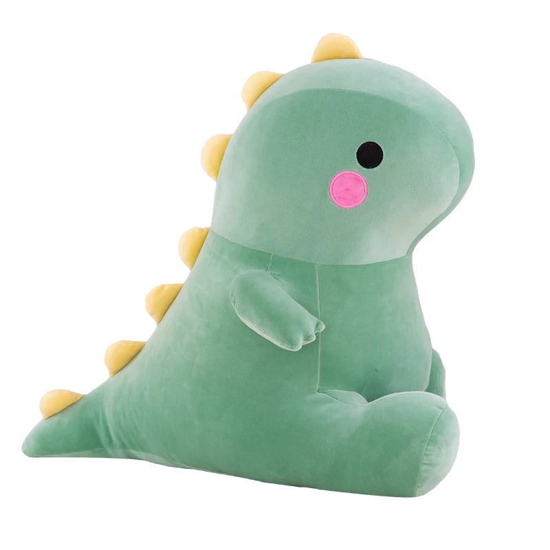 Green plush dinosaur toy with yellow spikes on a white background.