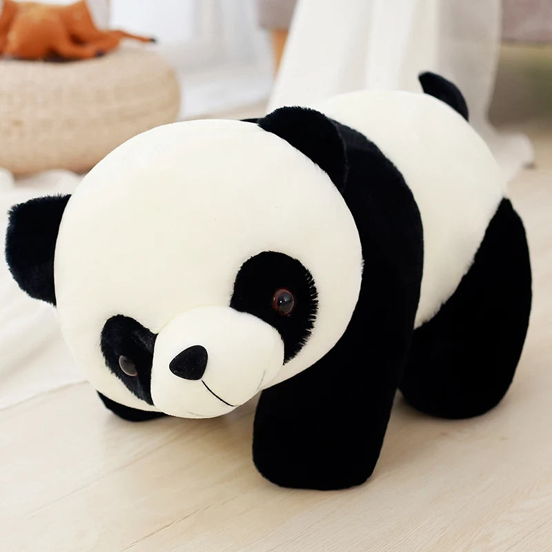 Plush panda toy on a light wooden floor with a blurred background.