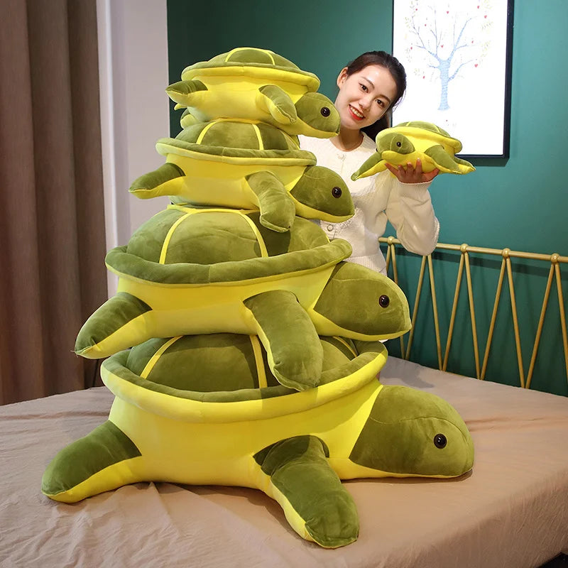 Green soft plush turtle toys stacked on top of each other.