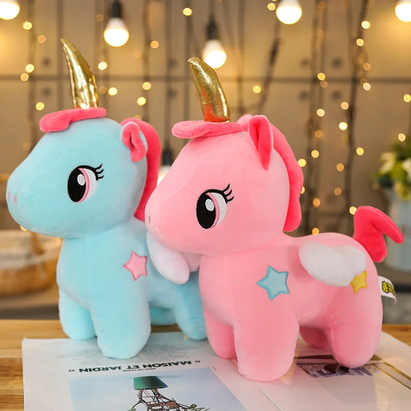 Two unicorn plush soft toys one blue and one pink.