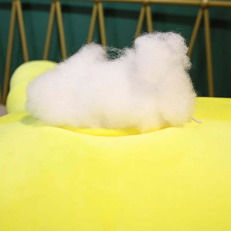 The open zipper of  a soft green plush turtle toy with some stuffing on show.