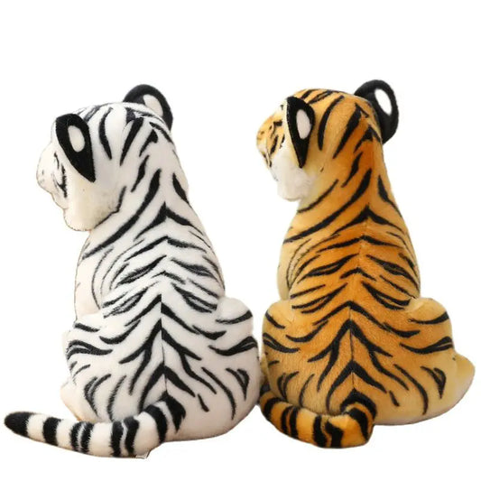 Two plush tiger toys, one white with black stripes and one orange with black stripes, on a white background.