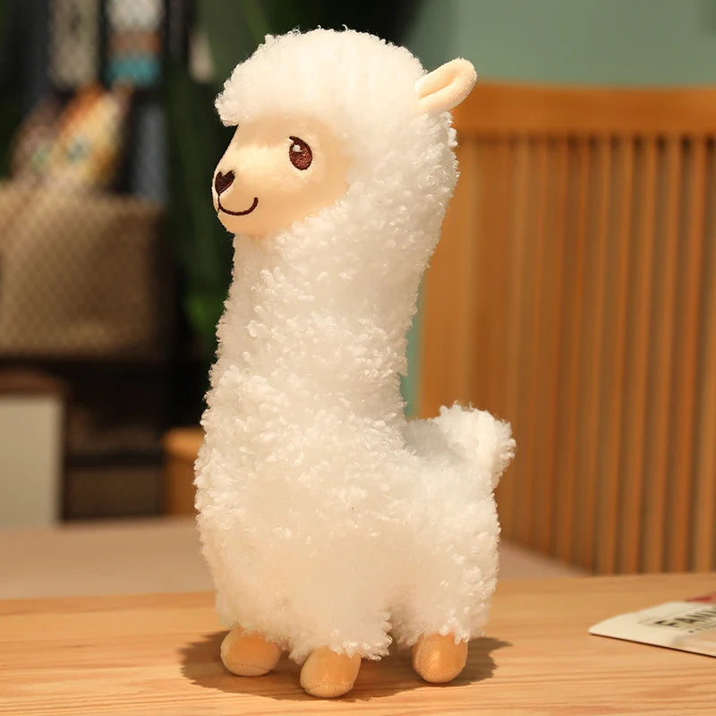 Plush toy llama on a wooden table with a blurred background