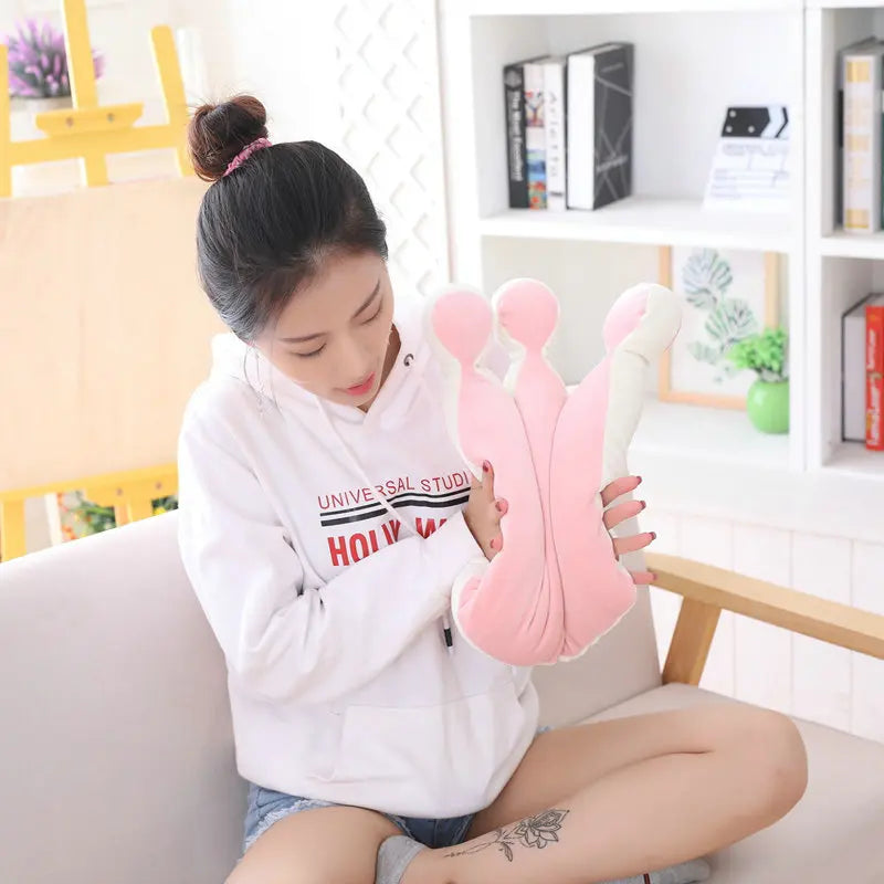 Person pushing the crown pillow from the sides to show softness and flexibility.