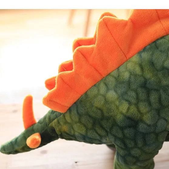 Close up off the tail and spikes of a soft plush stegosaurus dinosaur toy.