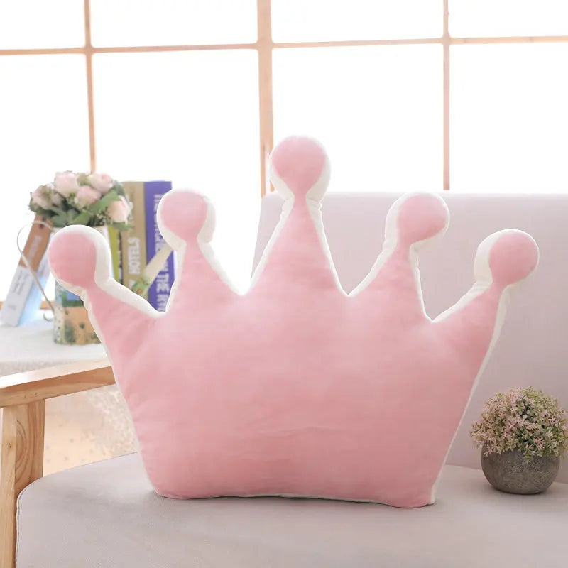 Pink plush crown pillow with rounded tips and cosy stuffed design