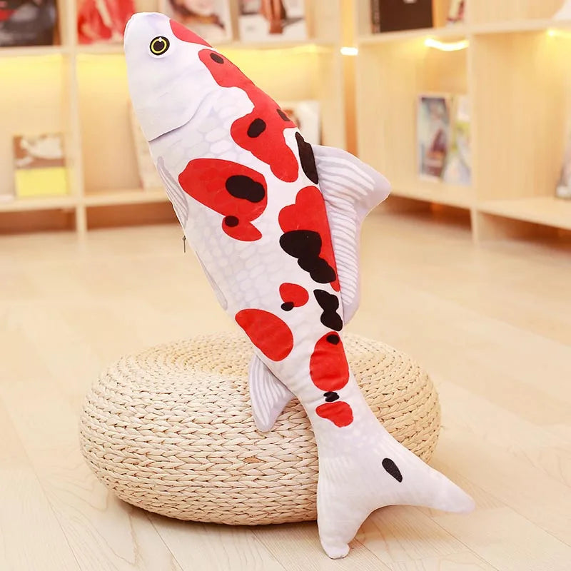 White koi fish soft toy with black and orange spots, displayed upright on a round woven stand