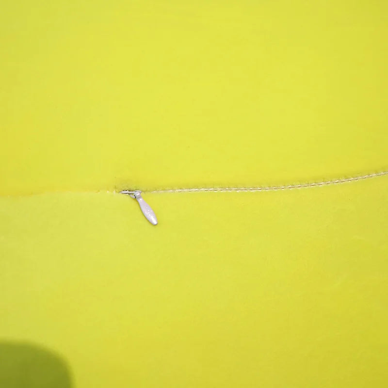 The closed zipper of  a soft green plush turtle toy.