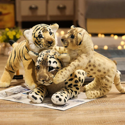 Lion, tiger and leopard soft plush toys on a table with a blurred background.