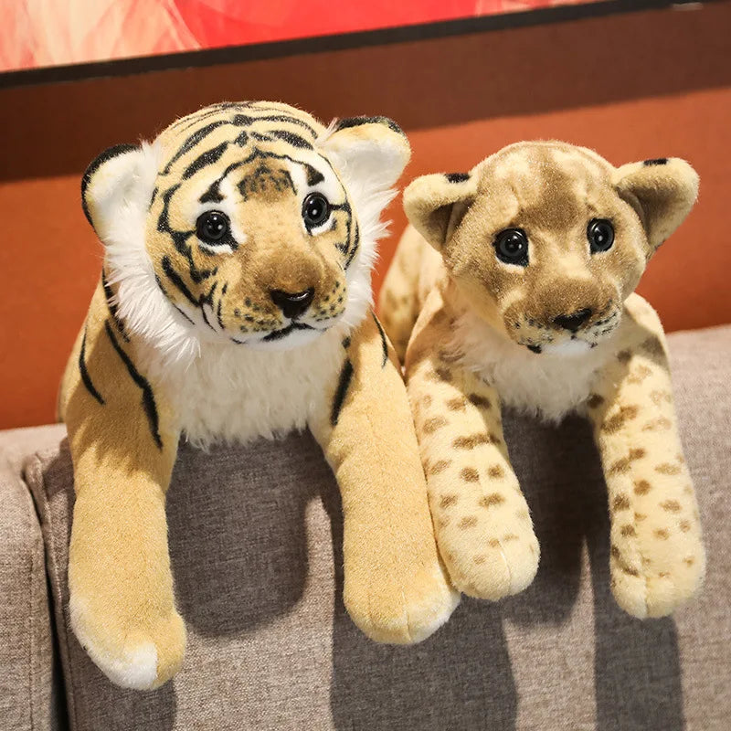 Plush tiger and lion toy sitting on a textured surface
