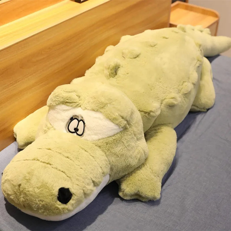 Big soft plush green crocodile on a soft surface.