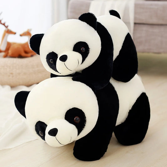 Two different sized panda soft toys on top of each other.