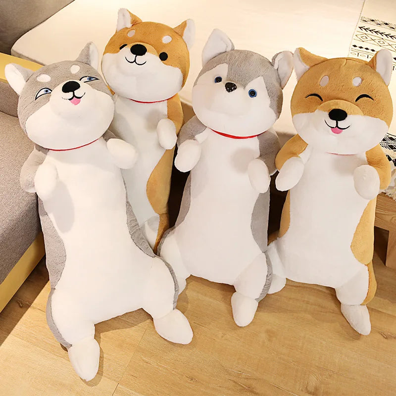 Four plush toys shaped like dogs on a wooden floor.