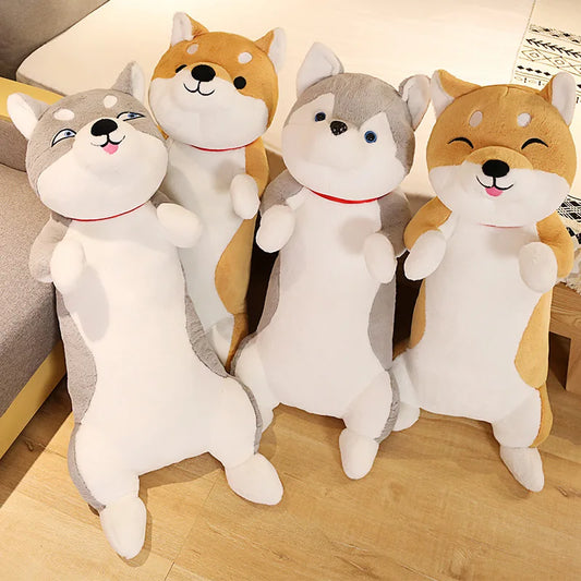 Four plush toys shaped like dogs on a wooden floor.
