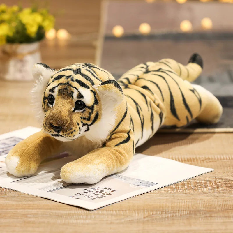 Plush tiger toy lying on a newspaper with a blurred indoor background