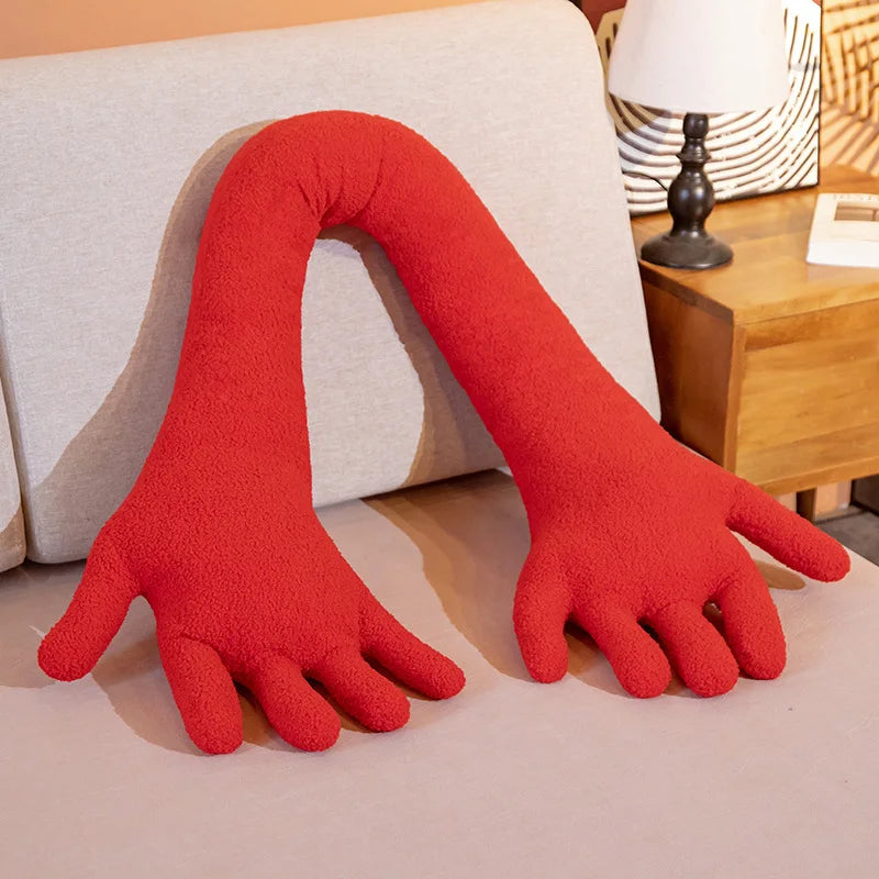 Red soft plush simulation hand on a couch.
