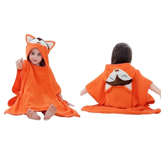 Child wearing an orange fox-themed hooded towel with a white background