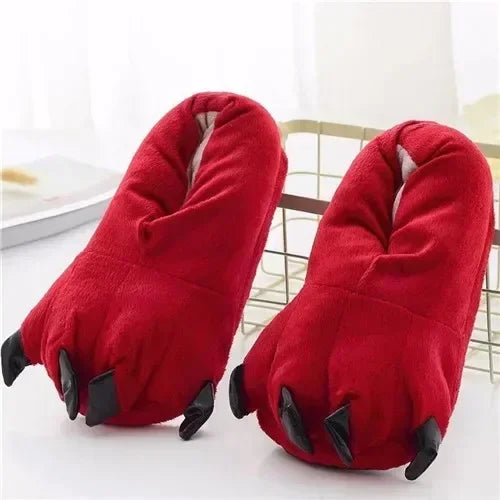 Red slippers with black clawed toes on a white surface
