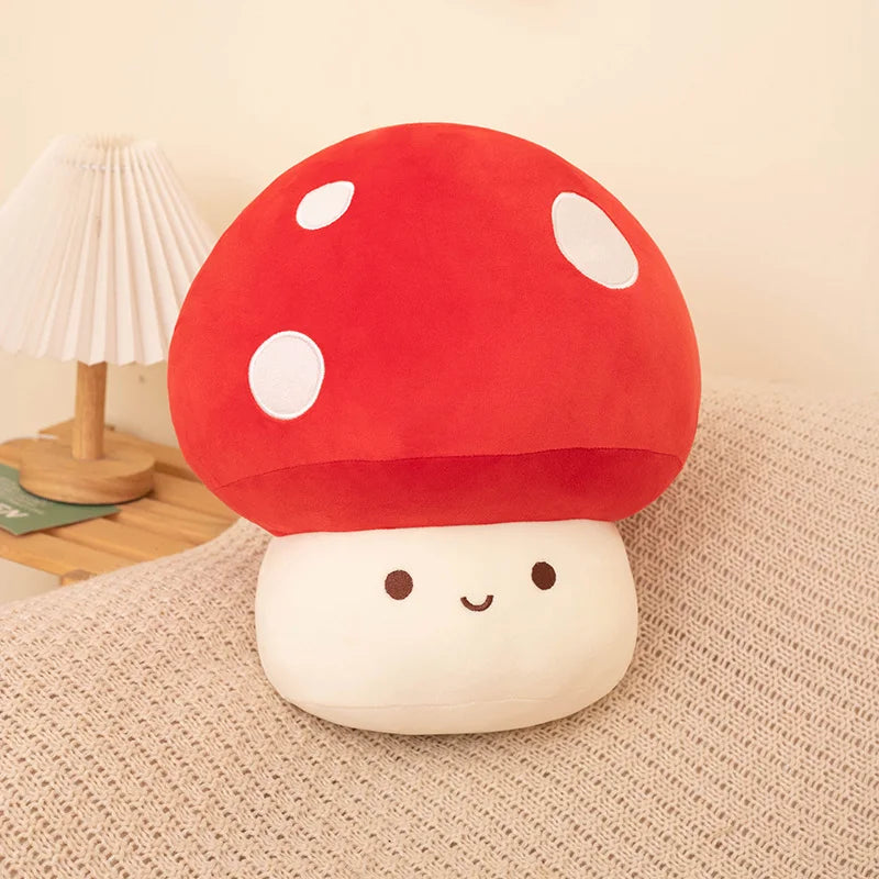 Red soft plush mushroom toy on a soft surface.
