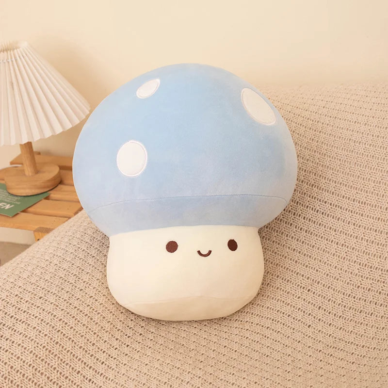 Blue soft plush mushroom toy on a soft surface.