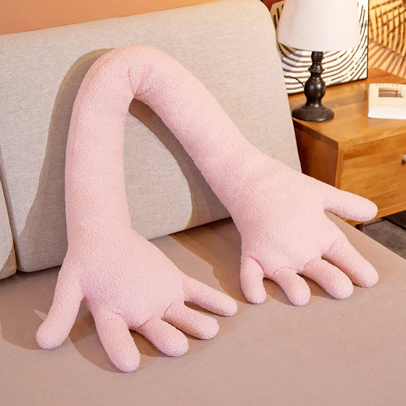 Pink soft plush simulation hand on a couch.