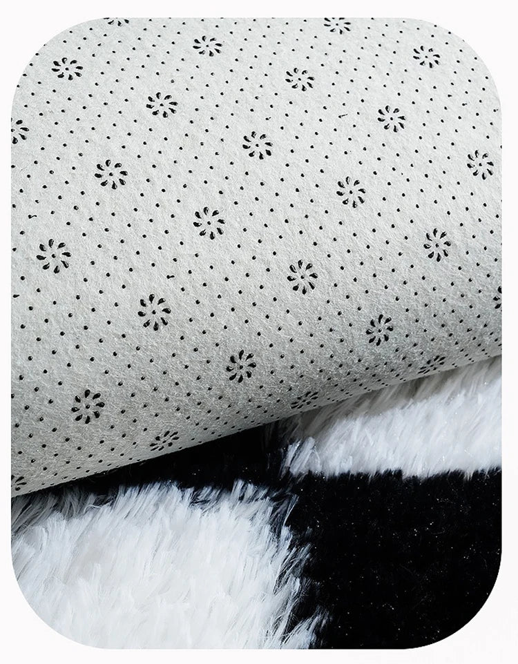 Close-up of a textured back of a black and white rug.
