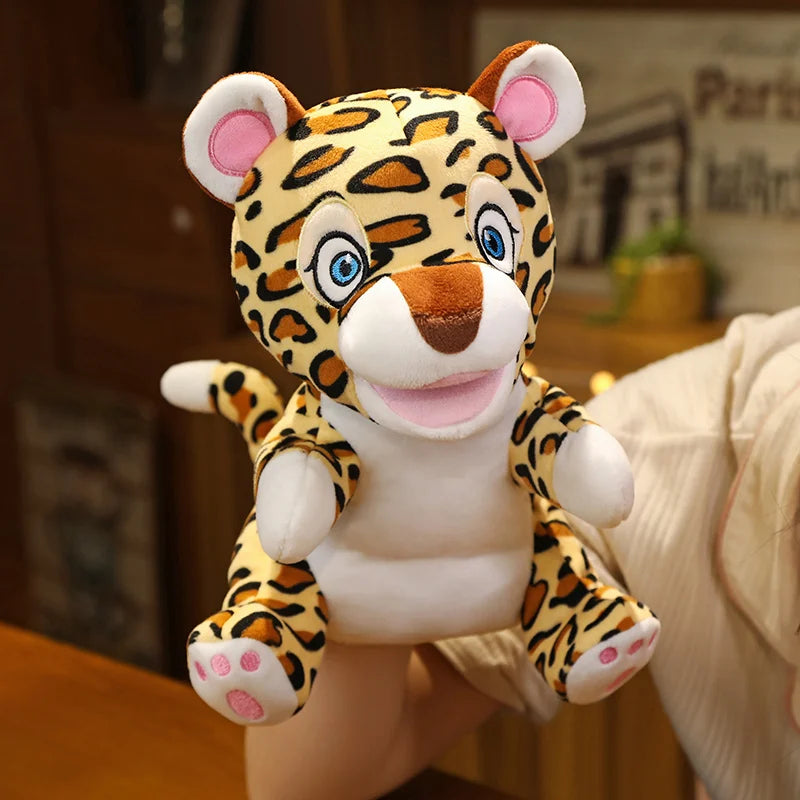 Plush leopard hand puppet held by a person with a blurred indoor background