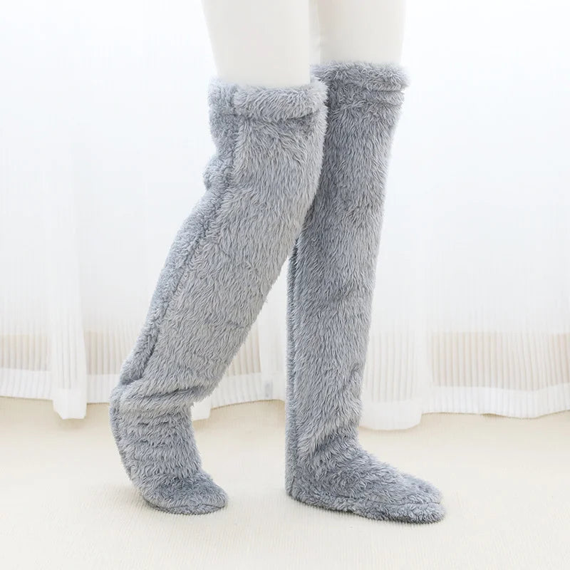 Light grey fuzzy knee-high socks on a white background