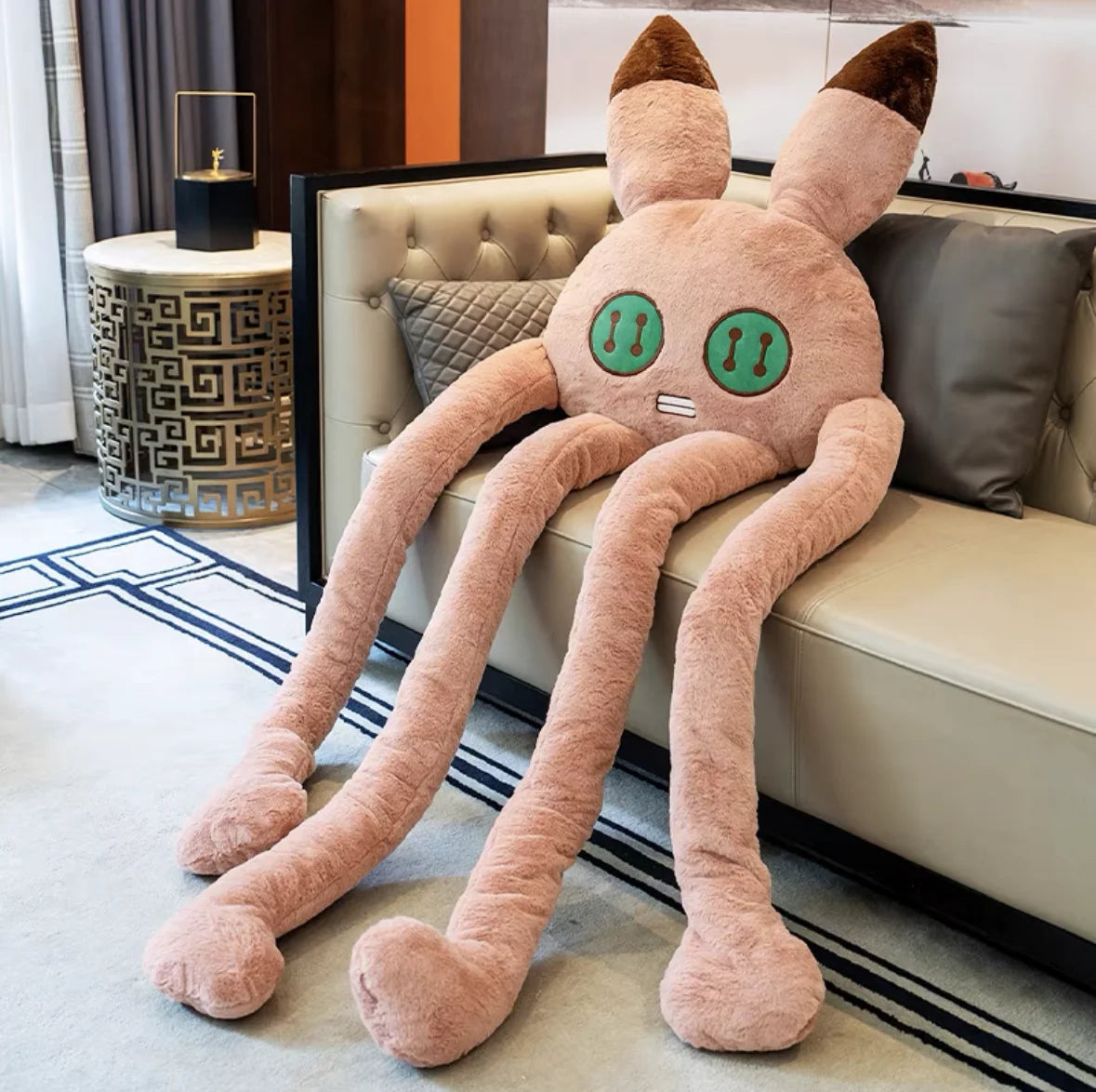 Pink long-legged bunny plush toy with soft floppy limbs and gentle character design