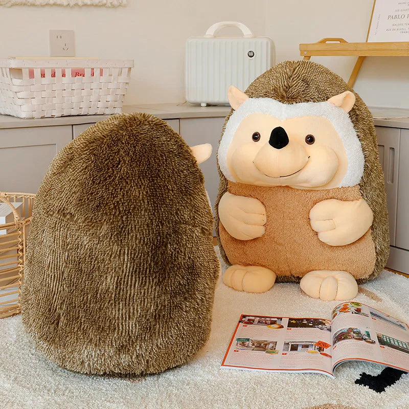 Two plush hedgehog toys on a carpeted floor with an open magazine nearby.